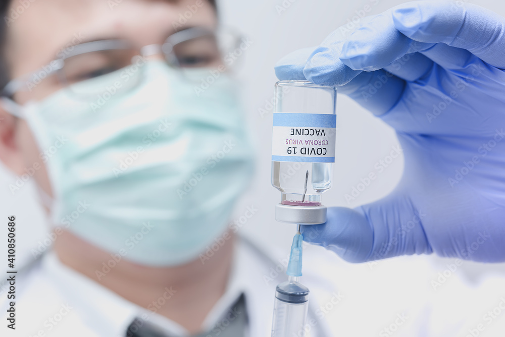 Vaccine injection,The doctor is preparing the vaccine and Syringe tube to Treatment sick person.Concept covid-19 vaccination medicine Vaccine injection,The doctor is preparing the vaccine and Syringe tube to Treatment sick person.Concept covid-19 vaccination medicine