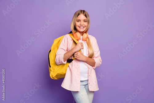 Photo of cheerful long hairdo pretty girl wear rucksack headphones pink shirt isolated on violet color background