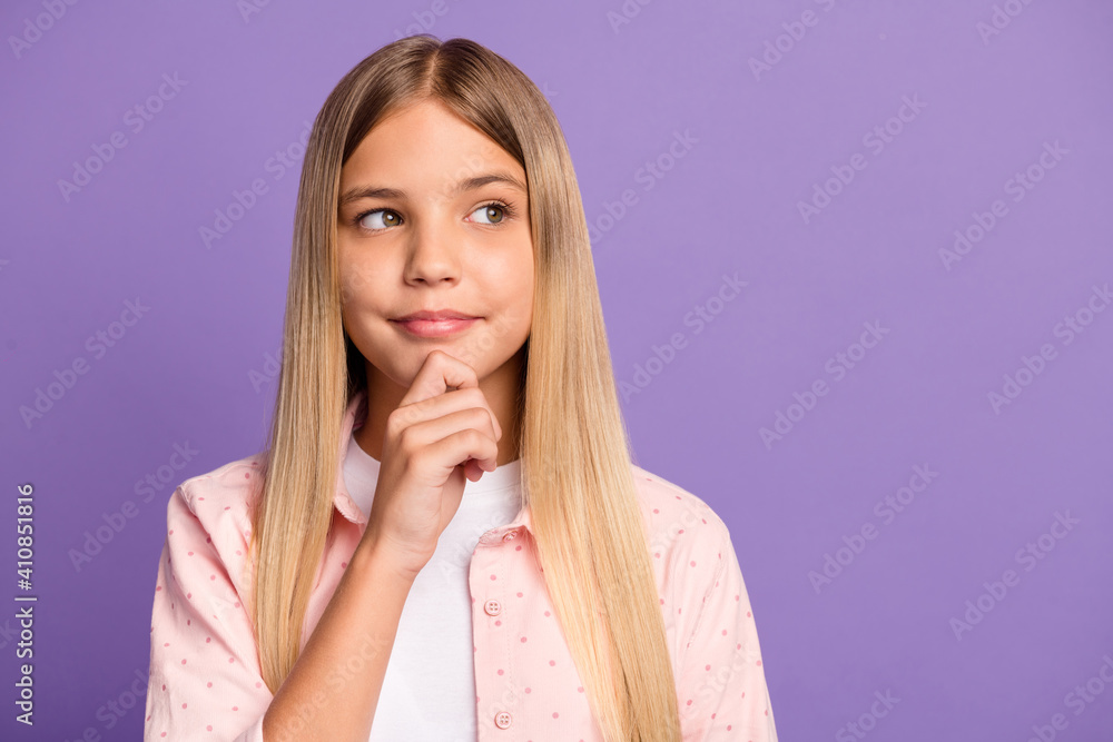 Portrait of cute long hairdo pretty girl look empty space hand chin wear pink shirt isolated on violet color background Portrait of cute long hairdo pretty girl look empty space hand chin wear pink shirt isolated on violet color background