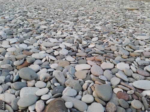 Photography Perspective of rounded sea pebble stones & rock on beach natural abstract pebble texture background