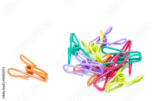 Plastic clothespins of various colors on white background