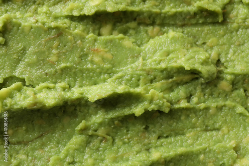Fresh guacamole texture on whole background, close up photo