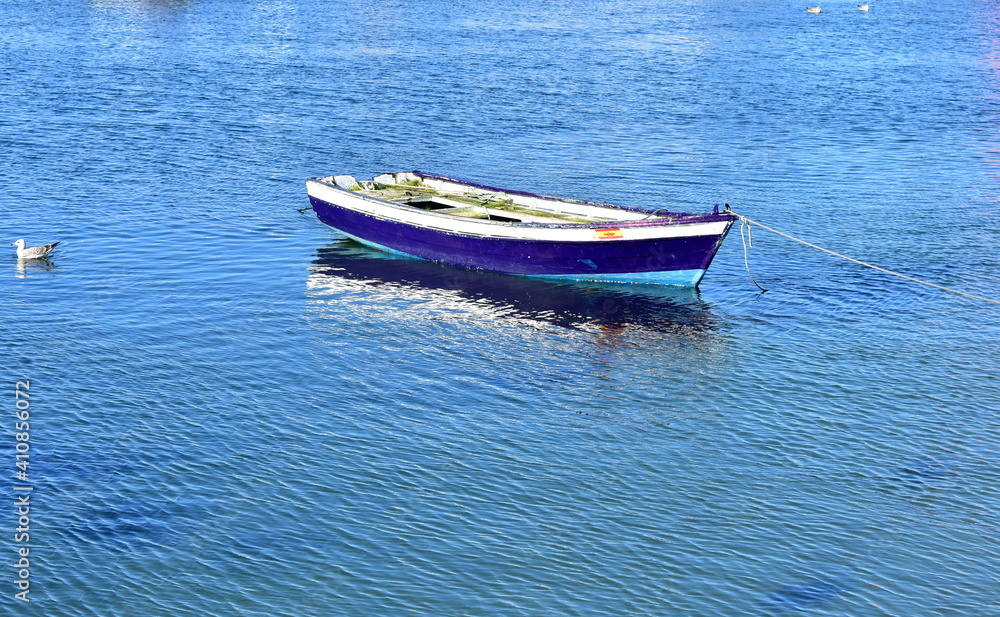 Old blue wooden small boat floating on the sea at famous Rias Baixas in Galicia Region. Spain.
Old blue wooden small boat floating on the sea at famous Rias Baixas in Galicia Region. Spain.