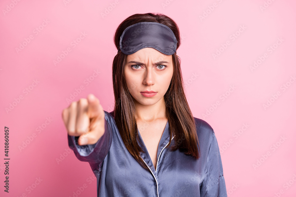 Photo portrait of angry girl pointing finger at camera isolated on pastel pink colored background Photo portrait of angry girl pointing finger at camera isolated on pastel pink colored background