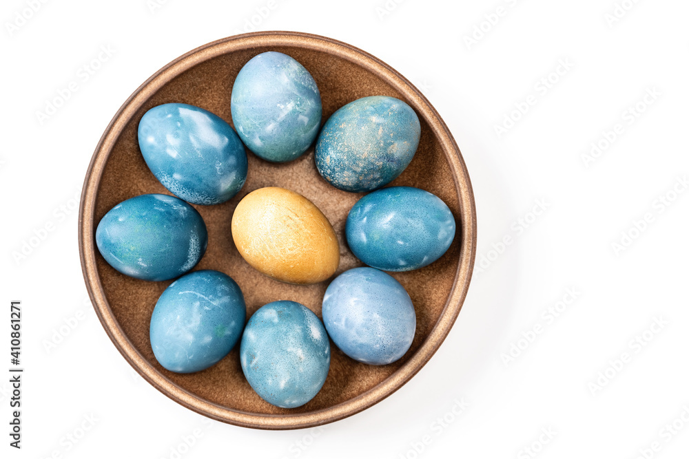 Different easter eggs in ceramic bowl on white Different easter eggs in ceramic bowl on white