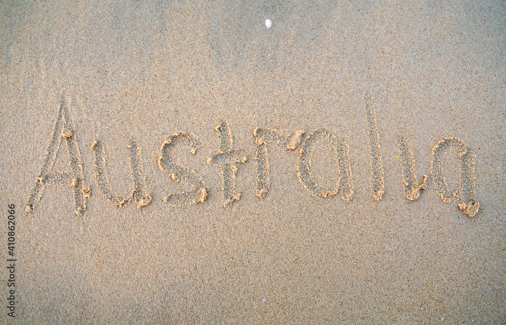 Fototapeta premium Australia words written on beach sand. Australia inscription is written on a sand.