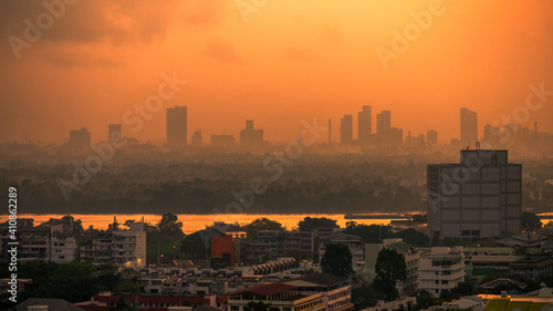 The blurred abstract background of the morning sun affected by the microscopic particles (Pm2.5) that surround the tall buildings in the capital, the long-term health problem of pollution.
