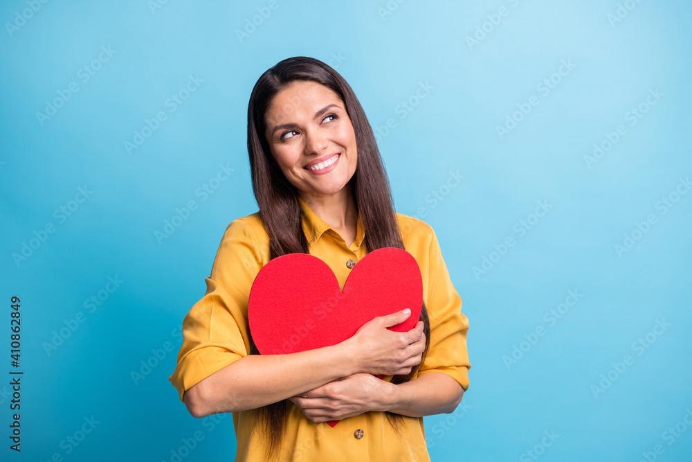 Photo of charming person hands hold hug red heart card look empty space isolated on blue color background Photo of charming person hands hold hug red heart card look empty space isolated on blue color background
