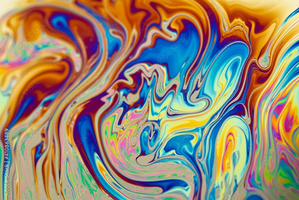 Brightly ornamental background with abstract patterns in dominant fiery orange color. Modern liquid art.  Mixed colors in soap bubbles, closeup.