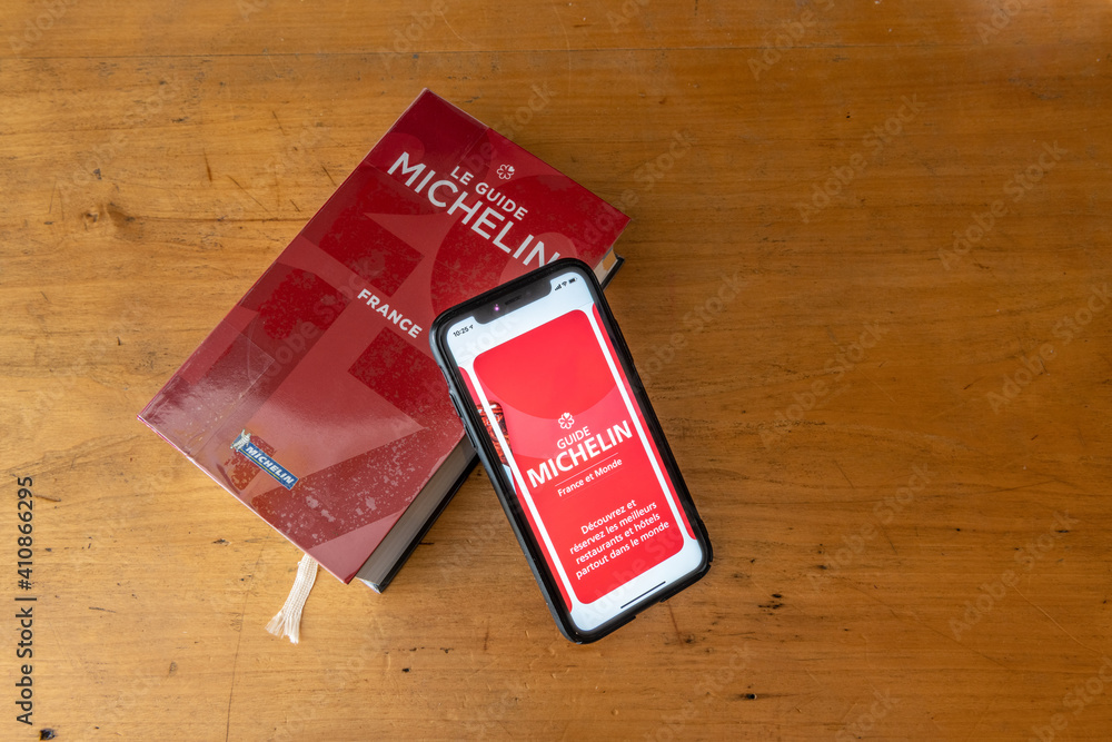 Paris, France - January 15, 2020 - Red Michelin guide book and smartphone  application, which reviews restaurants. Stock Photo | Adobe Stock