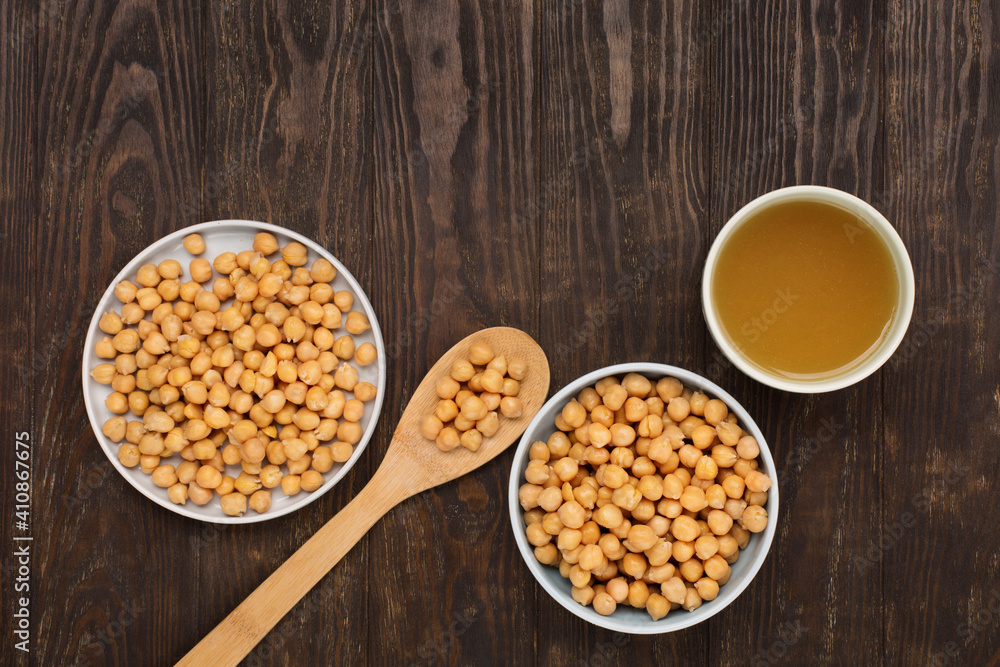 Cooked Chickpeas and chickpea aquafaba on dark wooden background. Cooked Chickpeas and chickpea aquafaba on dark wooden background.