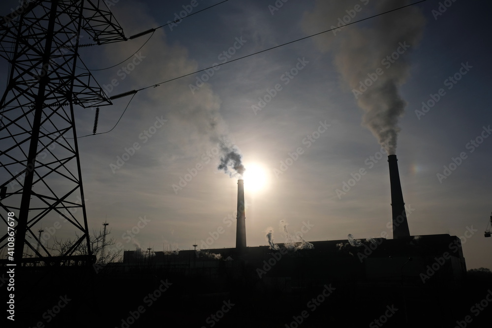 Almaty, Kazakhstan - 02.04.2021 : Silhouette of building, heating plant with Smoking chimneys