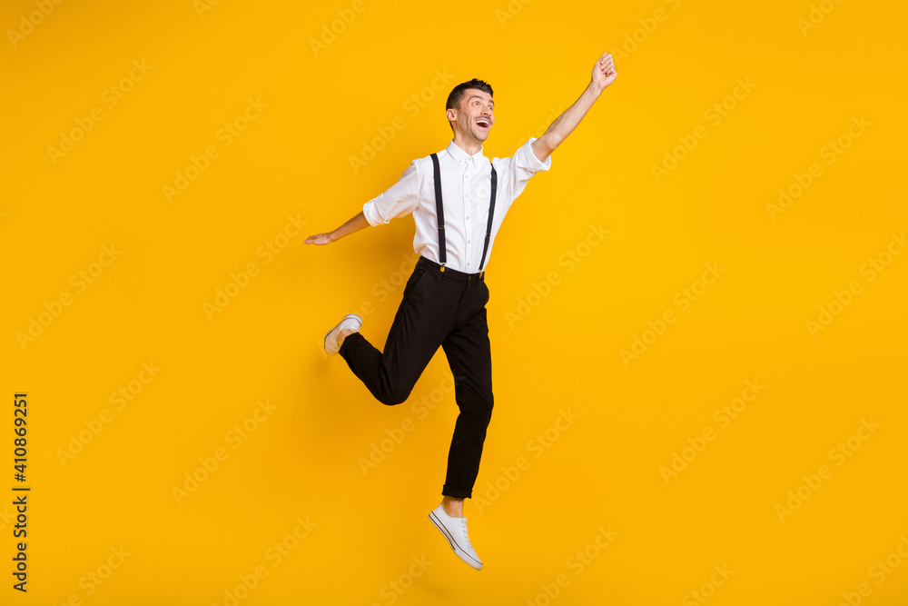 Full length body size photo jumping dreamy man keeping hand up imagine keeping umbrella isolated on vivid yellow color background