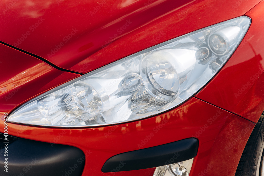 Car front light. Head Light of a red modern car