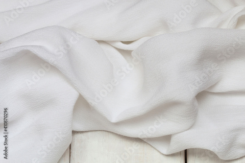 A soft white fabric background.