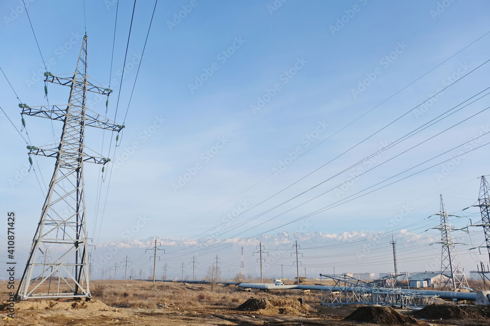 Almaty, Kazakhstan - 02.04.2021 : Power lines on the background of a large layer of smog covering the city and mountains. Almaty, Kazakhstan - 02.04.2021 : Power lines on the background of a large layer of smog covering the city and mountains.