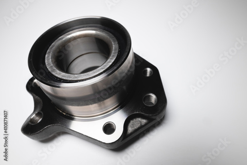 auto hub bearing new on gray background. metal spare part for front suspension