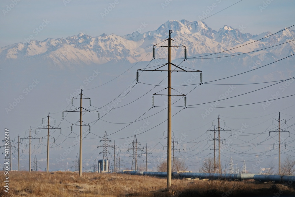 Almaty, Kazakhstan - 02.04.2021 : Power lines on the background of a large layer of smog covering the city and mountains. Almaty, Kazakhstan - 02.04.2021 : Power lines on the background of a large layer of smog covering the city and mountains.