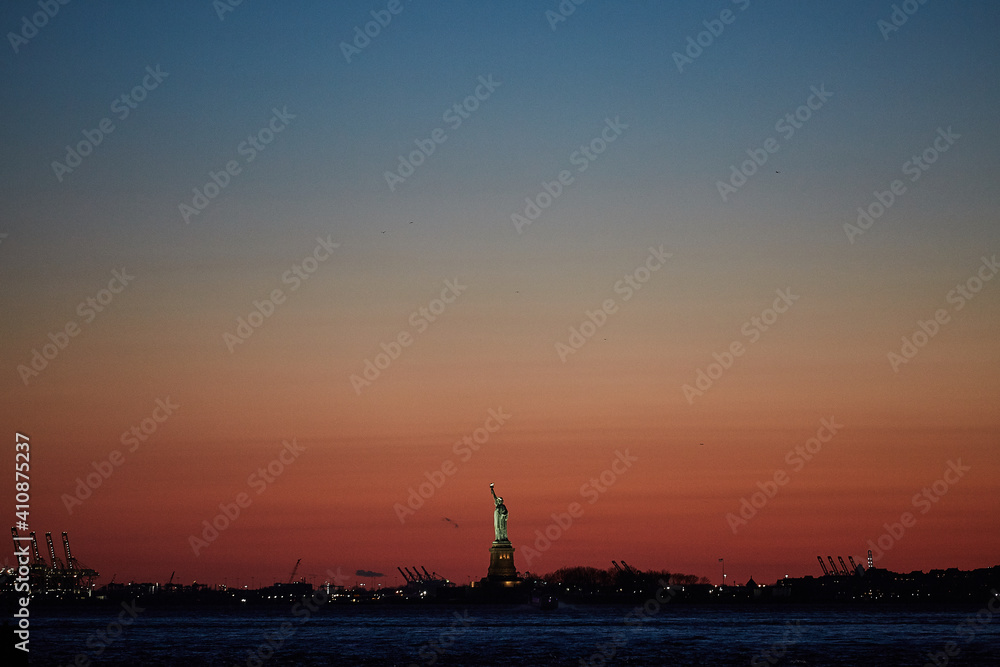 red sunset with the statue of liberty