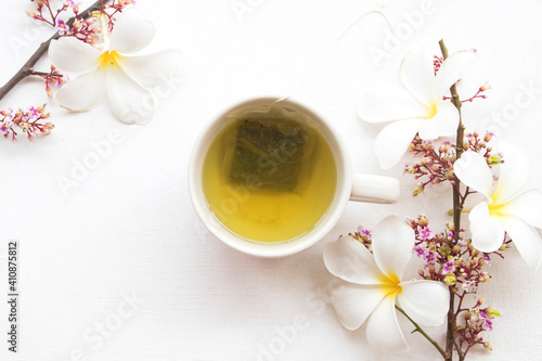 herbal health drinks hot green tea with flowers arrangement flat lay style on background white 