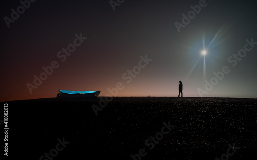 Man and boat by night. © Adrian