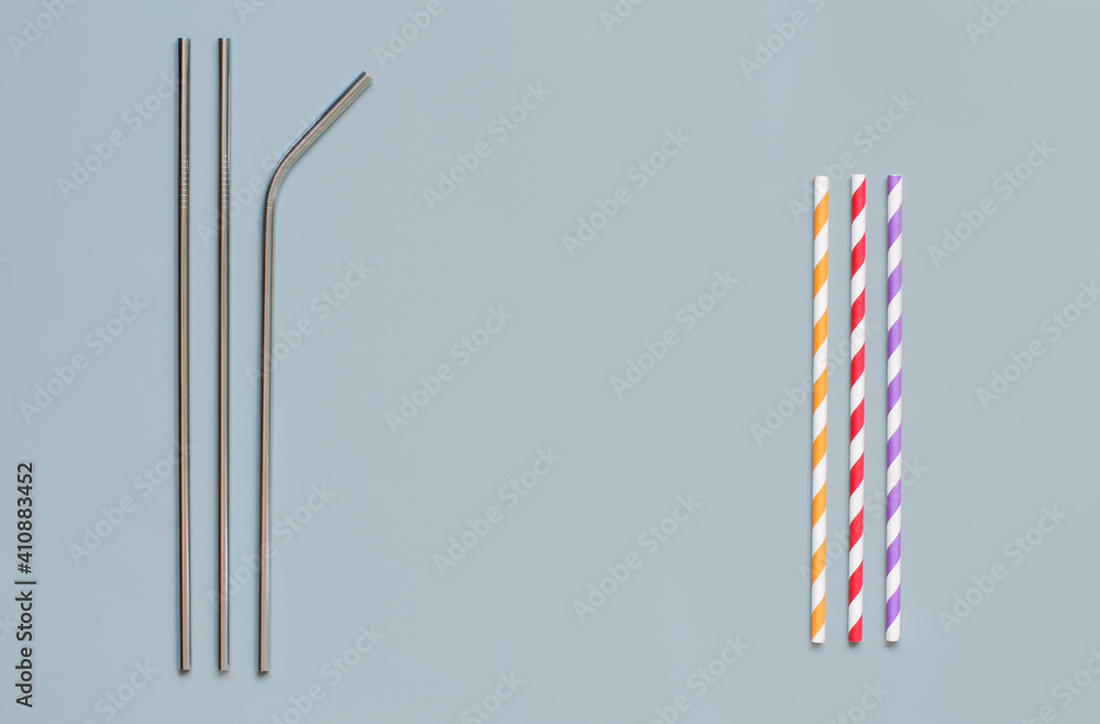 Steel and paper drinking straws on grey background Steel and paper drinking straws on grey background