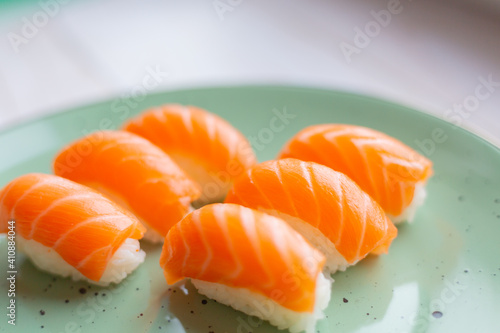 Sushi on a ceramic plate, rice and salmon