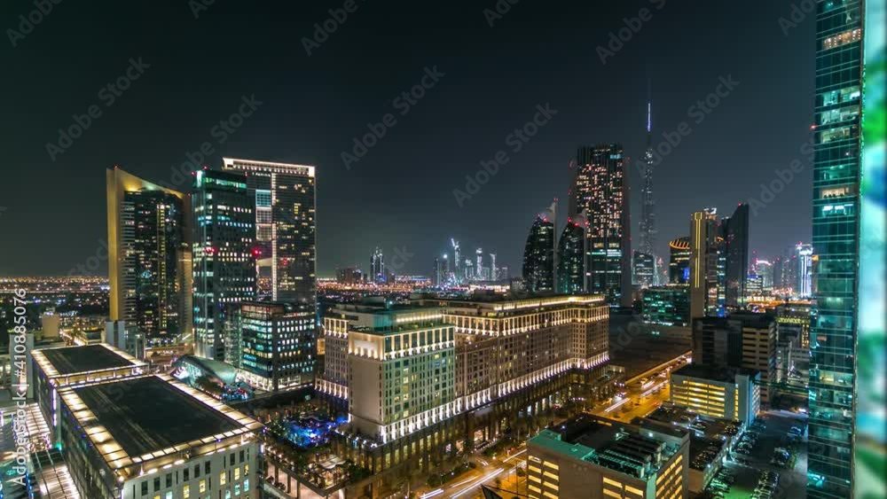 Dubai downtown architecture at night timelapse. Aerial view of numerous skyscrapers near Sheikh Zayed road. Illuminated towers and traffic near office buildings Dubai downtown architecture at night timelapse. Aerial view of numerous skyscrapers near Sheikh Zayed road. Illuminated towers and traffic near office buildings