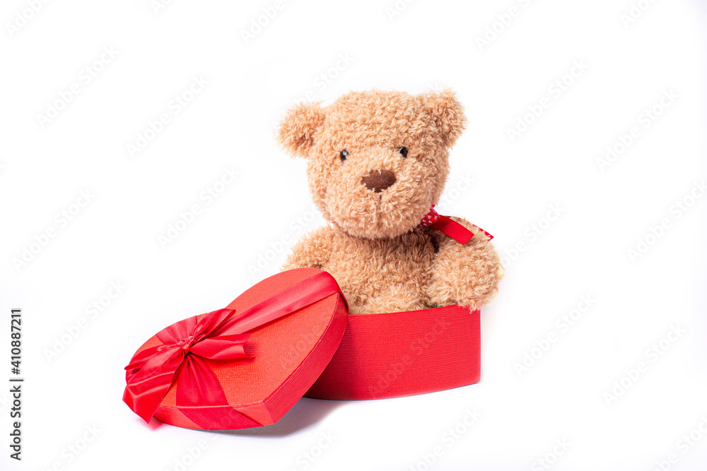 teddy bear sitting in a heart shaped box isolated on a white background teddy bear sitting in a heart shaped box isolated on a white background