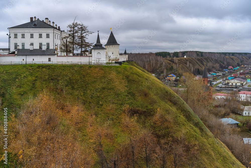 Panoramic view of Tobolsk city (Siberia, Russia) in autumn. On a high hill there is a white-stone old Kremlin with its towers and churches, and under the mountain there are houses of citizens