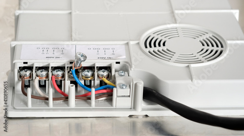 Electrical connection of the induction panel cooker, contacts, electricity. Pofessional wiring and installation hob in the kitchen photo