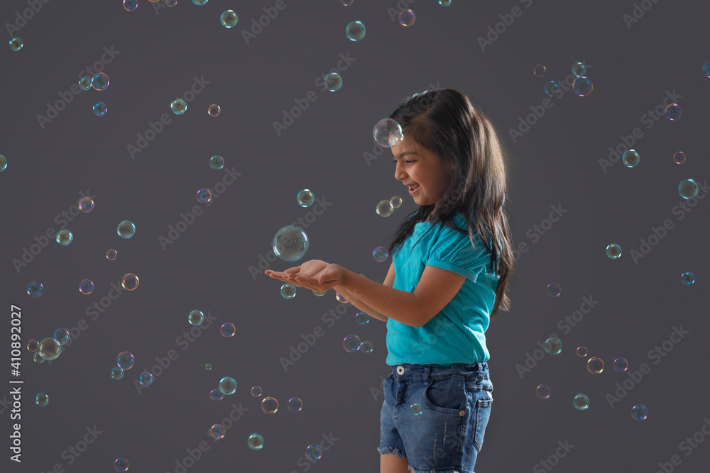 Fototapeta premium portrait of a young girl holding a bubble in her hand 