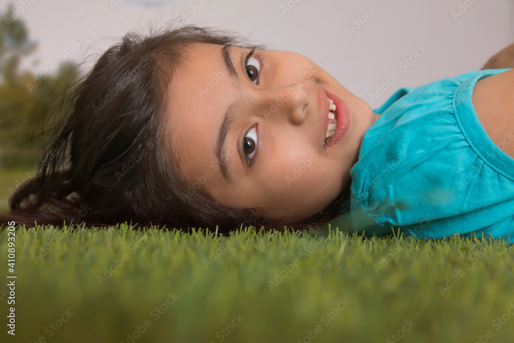 young girl lying down on grass young girl lying down on grass