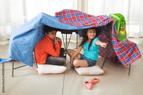brother and sister camping at home	