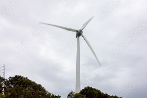 Wind turbine with motion blur effect in the Albany Wind Farm, AUstralia during overcast weather as way how to create green ecological electricity