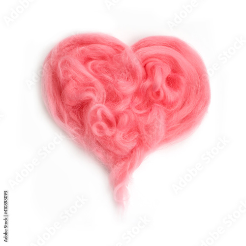 Pink  fluffy heart on a gray background made of wool