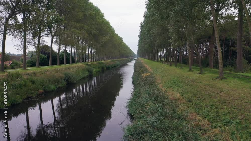 Aerial, pov, a treelined canal outside of Sint Laureins, Belgium Aerial, pov, a treelined canal outside of Sint Laureins, Belgium