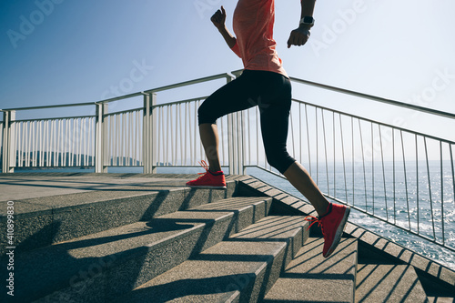 healthy lifestyle fitness sports woman runner running on seaside trail