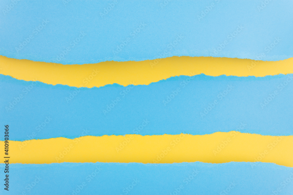 Ripped paper edge with copy space, blue and yellow color background. Flat lay. Copy space. Ripped paper edge with copy space, blue and yellow color background. Flat lay. Copy space.