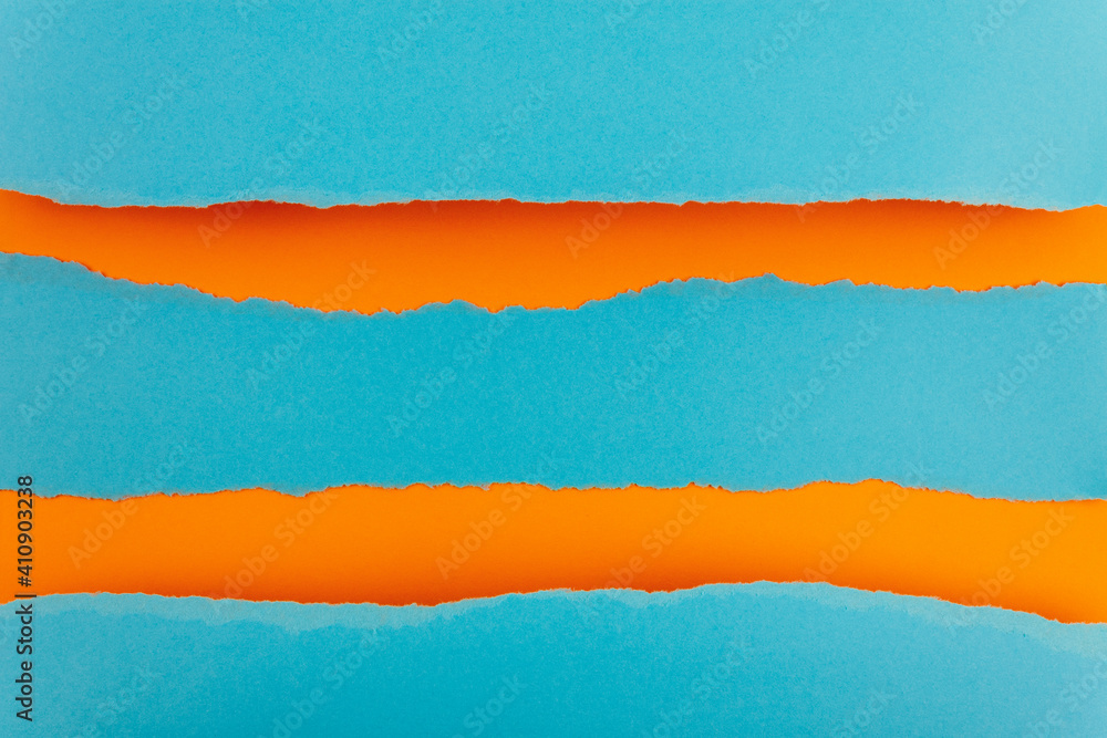 Ripped paper edge with copy space, blue and orange color background. Flat lay. Copy space. Ripped paper edge with copy space, blue and orange color background. Flat lay. Copy space.
