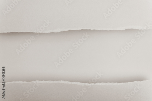 Ripped paper edge with copy space, beige background.  Flat lay. Copy space. © DRasa