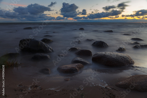 Fototapeta Naklejka Na Ścianę i Meble -  Rocky sea coast at blue hour. Long exposure. Baltic sea.