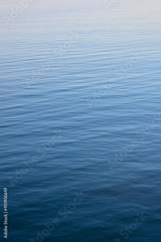 Stockholm archiepelago, Sweden. July, 25,2014. Calm water with gradient coloured ripples vertical