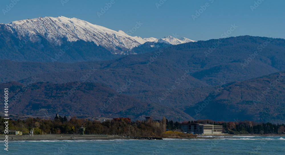 View of snowy peaks of Caucasian mountains in Abkhazia across Black Sea from Russian side.