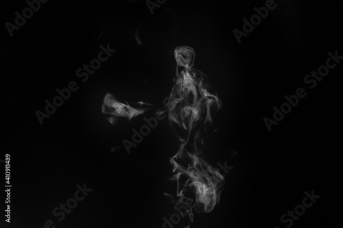 Smoke fragments on a black background. Abstract background, design element, for overlay on pictures. © Alena
