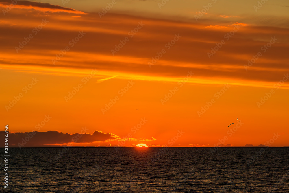 Colorful tropical sunset above line of  the horizon