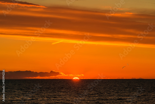 Colorful tropical sunset above line of  the horizon