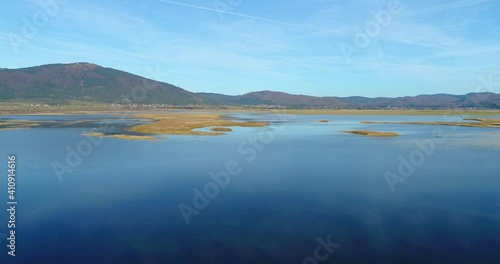 One of the largest intermittent lakes in Europe lake Cerknica. Aerial view of amazing landscape in Slovenia. Drone ascend above karst pond
