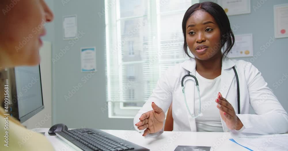 Close up of pregnant woman visit african american gynecologist doctor at hospital or medical clinic for pregnancy consultant. Doctor talking with pregnant woman. Pregnancy and maternity concept. Close up of pregnant woman visit african american gynecologist doctor at hospital or medical clinic for pregnancy consultant. Doctor talking with pregnant woman. Pregnancy and maternity concept.