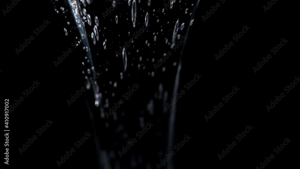 clear glucose. viscous glucose pours beautifully on a black background. close-up clear glucose. viscous glucose pours beautifully on a black background. close-up